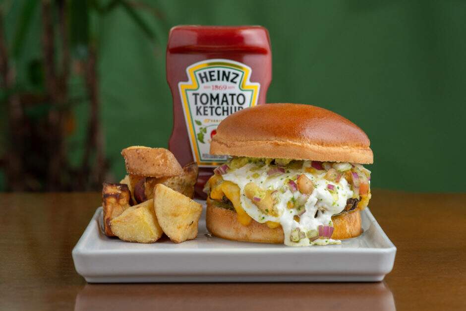 Pao, maionese de avocado e manjericão, burguer de feijão e grão de bico, mix de cheddar e mussarela, pico e galo e creme azedo.